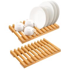 a wooden rack with plates and cups on it next to another set of white dishes