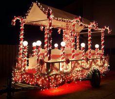 a covered wagon decorated with christmas lights and candy canes