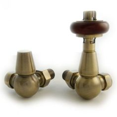 two brass colored knobs with wooden handles