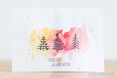 a card with watercolor trees on it