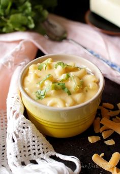 a yellow bowl filled with macaroni and cheese