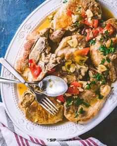 a white plate topped with meat and vegetables