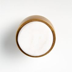 a close up of a wooden object on a white surface