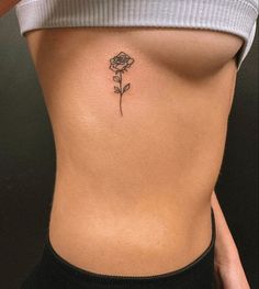 a woman with a rose tattoo on her stomach