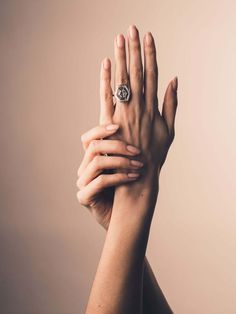 a woman's hand with a ring on it