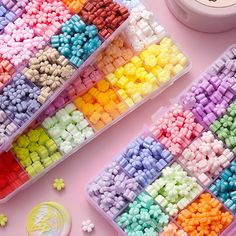 there are many different colors of beads in the plastic trays next to each other