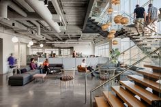 people are sitting on the stairs in an office