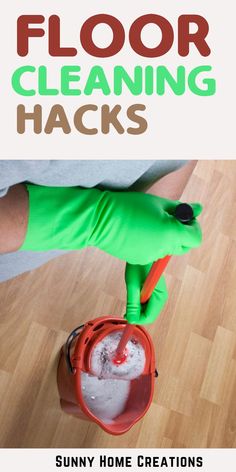 a person in green gloves is cleaning the floor with a bucket full of ice and water