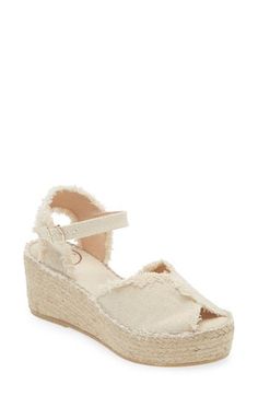 A woven platform and wedge heel underscore the espadrille-inspired style of this summery sandal finished with frayed trim. 2 1/2" heel, 1 1/2" platform (size 39w) Textile upper/synthetic lining and sole Made in Spain Natural Espadrille Wedge Sandals For Spring, Cream Platform Espadrilles With Ankle Strap, Cream Ankle Strap Platform Espadrilles, Cream Espadrille Sandals For Summer, Summer Cream Platform Espadrilles, Cream Espadrille Sandals For Vacation, Cream Wedge Heel Espadrilles For Spring, Cream Platform Espadrilles For Vacation, Cream Ankle Strap Espadrille Sandals