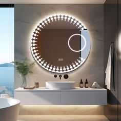 a bathroom with a sink, mirror and bathtub next to the ocean in front of it