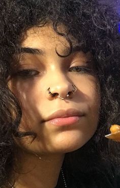 a close up of a person with a nose piercing