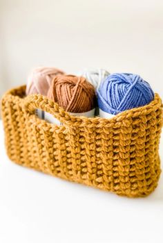 three balls of yarn are in a basket