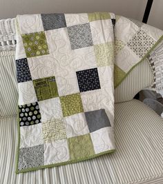 two quilts sitting on top of a couch next to each other