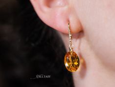 These earrings are composed of the most amazing genuine, natural Madeira Citrines. These red-carpet worthy gemstones are absolutely clean and have an intense golden color. They hang from Solid Gold 14k gold unique earwires that are set with 5 diamonds each. ⭐ DETAILS: ✓ Length including earwires: 1.4″ (about 3.5 cm) ✓ Gold: All the [...] Oval Citrine Gemstone Earrings, Elegant Oval Citrine Earrings, Citrine Earrings, Natural Citrine, Golden Color, Oval Diamond, Citrine, Red Carpet, Solid Gold