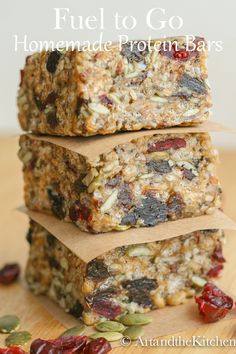 three granola bars stacked on top of each other with cranberries and sunflower seeds