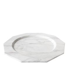 a white marble plate with a hexagonal design on the rim, against a white background