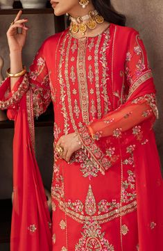 Stunning Red Embroidered Pakistani Salwar Kameez Wedding Dress is a mesmerizing ensemble that harmonizes the boldness of deep red with the allure of gold. The heavy dupatta with meticulous hem work makes it a captivating choice for weddings. Embroidered Kameez: A red-golden long kameez is designed with a scheduled embroidered front, our embroidered long shirt back, embroidered sleeves, and a border with an embellished neckline that has gorgeous tilla and resham embroidery on it. The fabric used Vogue Clothing, Salwar Kameez Wedding, Pakistani Winter Dresses, Heavy Dupatta, Pakistani Clothes Online, Clothing Studio, Salwar Dress