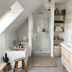 an attic bathroom with white walls and flooring