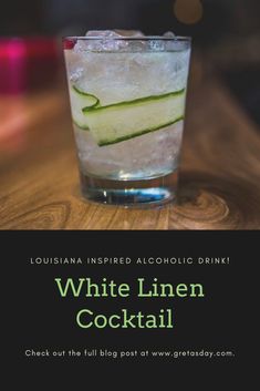 white linen cocktail with cucumber on the side and text that reads, louisiana inspired alcoholic drink