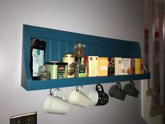 tea cups and coffee mugs are hanging on the wall