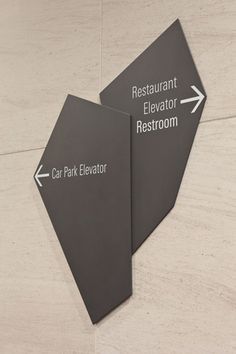 two signs on the floor pointing to different restaurants and restraunts in each direction