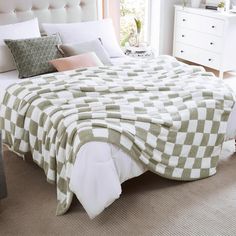 a bed with a checkered blanket on top of it