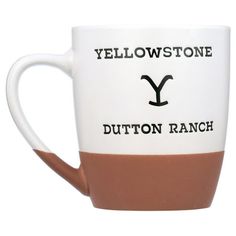 a white and brown coffee cup with the words yellowstone on it