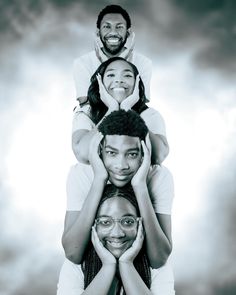 a group of people standing in the air with their heads on each other's shoulders