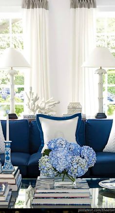 a living room filled with blue and white furniture