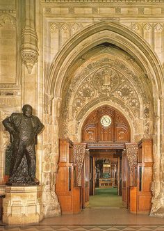 the entrance to an ornate building with statues