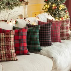 a white couch with christmas pillows on it