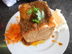 a white plate topped with meat and gravy