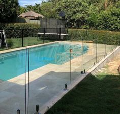 an empty swimming pool with fence around it