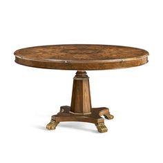 a round wooden table with gold trimmings