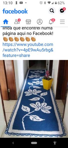 an image of a blue rug on the floor with white flowers and leaves in it