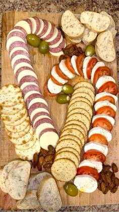 a wooden cutting board topped with different types of food