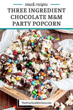 chocolate m & m party popcorn recipe on a wooden table with text overlay that reads snack recipes three ingredient chocolate m & m party popcorn