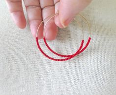 These hoops are dainty and carry high quality red seed beads. Also available with other metals (choose preference at checkout) ❤ SIZES They measure 45 mm in diameter. ❤ PROCESSING AND SHIPPING Most orders are made and shipped out in one business day. Please check delivery timeframes for your location on the description below. ❤ CUSTOM ORDERS Contact me to discuss you needs! Go back to my shop: https://www.etsy.com/shop/StephanieMartinCo See more fabulous earrings here: https://www.etsy.com/shop/ Bohemian Red Hoop Earrings With Colorful Beads, Nickel Free Red Hoop Earrings, Nickel-free Red Hoop Earrings, Handmade Red Beaded Hoop Earrings, Red Hoop Earrings With Colorful Beads For Jewelry Making, Adjustable Red Hoop Earrings With Dangling Beads, Red Hoop Jewelry With Colorful Beads, Red Hoop Earrings With Tiny Beads, Red Wire Wrapped Hoop Earrings