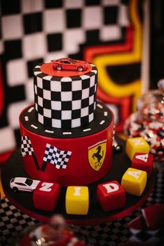 a red and black cake sitting on top of a table