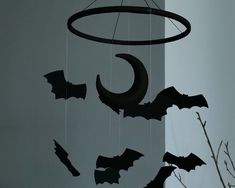 a mobile with bats hanging from it's sides and a moon in the middle