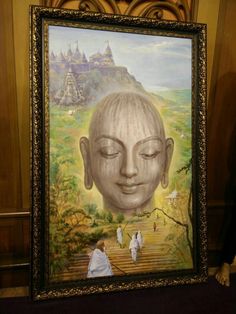 a painting of a buddha head on display in a museum