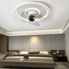 a large bed sitting under a ceiling fan