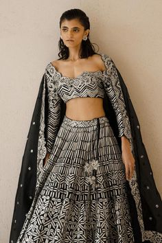 Black lehenga with all-over metallic tape and sequin embroidery. Comes with full length sleeves matching blouse and border embroidered dupatta.
Component: 3
Pattern: Embroidery
Type Of Work: Metallic tape and sequin embroidery
Neckline: Scoop
Sleeve Type: Long
Fabric: Silk Organza
Color: Black
Other Details: 
Dupatta with floral embroidered border
Lehenga with cutwork hem
Closure: Blouse: Side zip
Occasion: Sangeet - Aza Fashions Embroidery Neckline, Organza Embroidery, Black Lehenga, Embroidered Border, Sequin Embroidery, Embroidered Dupatta, Luxury Sale, Pattern Embroidery, Sequins Embroidery