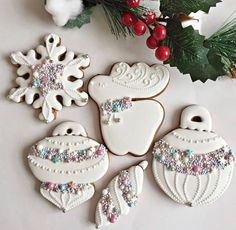 decorated christmas cookies and decorations on a table