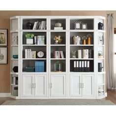 a white bookcase with lots of books on it