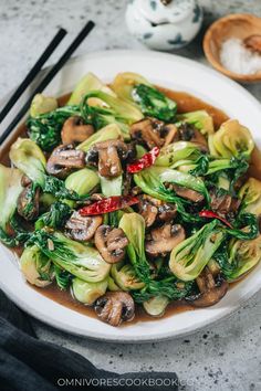 a white plate topped with stir fried vegetables