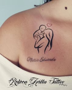 a woman with a tattoo on her shoulder holding a baby in her arms and the words,