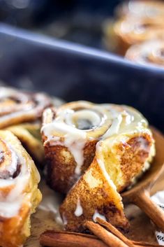 cinnamon rolls with icing and cinnamon sticks