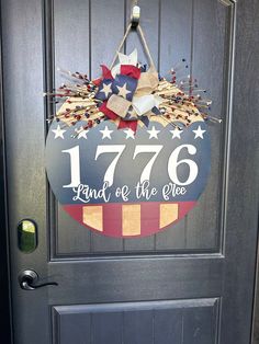 a patriotic door hanger with the number seventy and an american flag wreath on it