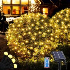 solar powered landscape lights in front of a house with trees and bushes at night time